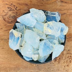 May include: A bowl filled with a variety of milky white and translucent opal crystal chunks.