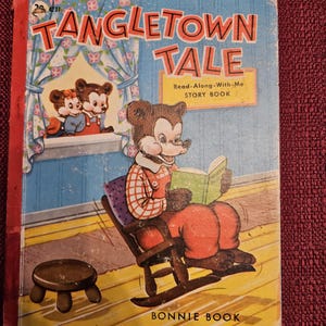 May include: A vintage children's book titled "Tangletown Tale" with a red cover and a cartoon bear reading a book in a rocking chair. The book is a "Read-Along-With-Me Story Book" published by Bonnie Book.