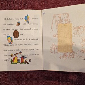 May include: An open book with illustrations of children playing on a swing set and a girl with a barrel. The text on the page reads "He looked so funny that couldn't help laughing. said, "Please excuse my looks. You see, I just happened to bump into the here." smiled and her twinkled. "That's quite all right," she said. "Things were getting a little dull here anyhow. Per haps the family is just what we needed here in"