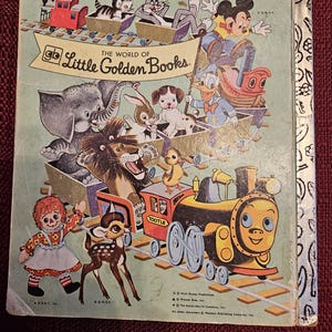 May include: A vintage Little Golden Book cover featuring a colorful train with various cartoon characters, including Mickey Mouse, Donald Duck, and a deer. The book's title is "The World of Little Golden Books."
