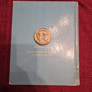 May include: Blue book with a gold Wonder Books logo featuring two children reading. The text on the back cover reads "With washable covers. Other Wonder Books are listed at the end of this story."