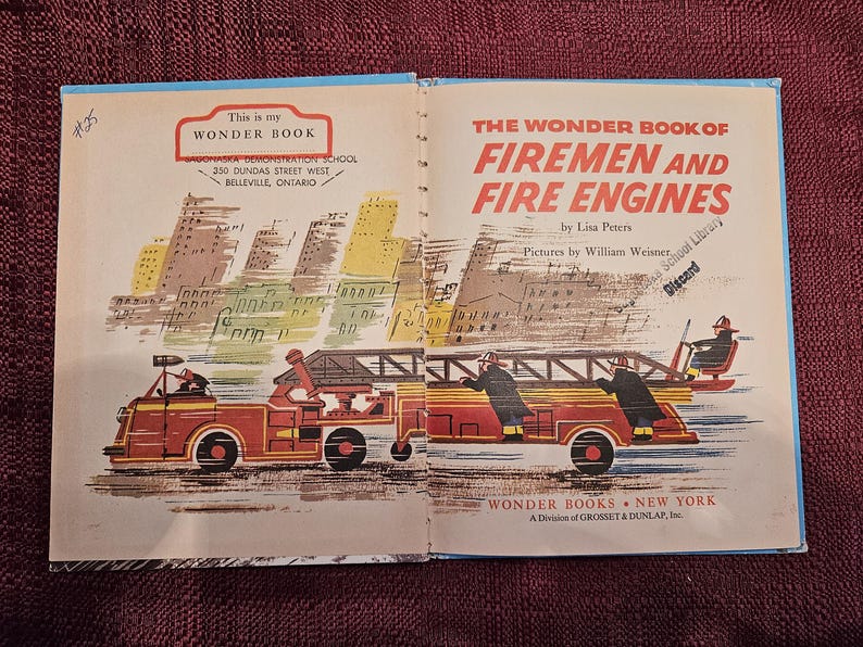 May include: A vintage children's book titled "The Wonder Book of Firemen and Fire Engines" by Lisa Peters, illustrated by William Weiner. The cover features a red fire engine with firefighters driving through a city.