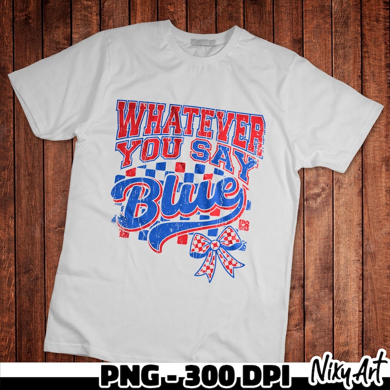 May include: White t-shirt with red, white and blue text that says "Whatever You Say Blue" with a red, white and blue bow.