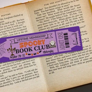 May include: A purple and white bookmark with a spiderweb design and the text "Lifetime Membership Spooky Book Club October 29-31 Midnight". The bookmark also has a ticket with the text "Admit One" and a barcode.