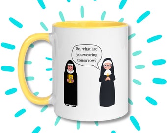 May include: White ceramic mug with a yellow rim. The mug features a cartoon illustration of two nuns, one asking the other "So, what are you wearing tomorrow?"