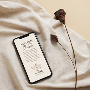 May include: A smartphone displaying a welcome message for a spiritual reading service called "NASIRA spiritual readings". The message reads "Welcome to our journey. Welcome to a world of insight and enlightenment. I'm honored that you've chosen me for your tarot reading. With the cards as our guide, we'll unlock the wisdom within and shed light on your path. May your journey be filled with newfound clarity and positive energy."