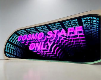 May include: A rectangular sign with a black background featuring the repeating white text KIDLAVIE and a central, glowing neon pink sign that reads COSMO STAFF ONLY. The sign has a light-colored frame and creates a deep, mirrored infinity effect.