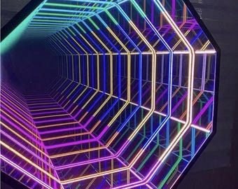 May include: An octagonal light fixture with a mirrored interior, showcasing a tunnel of colorful neon lights. The lights cycle through shades of purple, pink, yellow, green, and blue, creating a vibrant, geometric display.