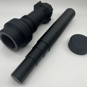 May include: A set of three black plastic pieces, including a telescoping tube, a round cap, and a piece with a hexagonal top and a round bottom.