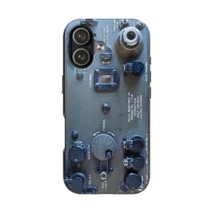 May include: A phone case featuring a detailed design resembling a vintage military radio control panel. The case is primarily olive green with black knobs, dials, and text, including "CHANNEL", "TUNING", and "AUX PHONE". The design includes a dual-lens camera cutout.