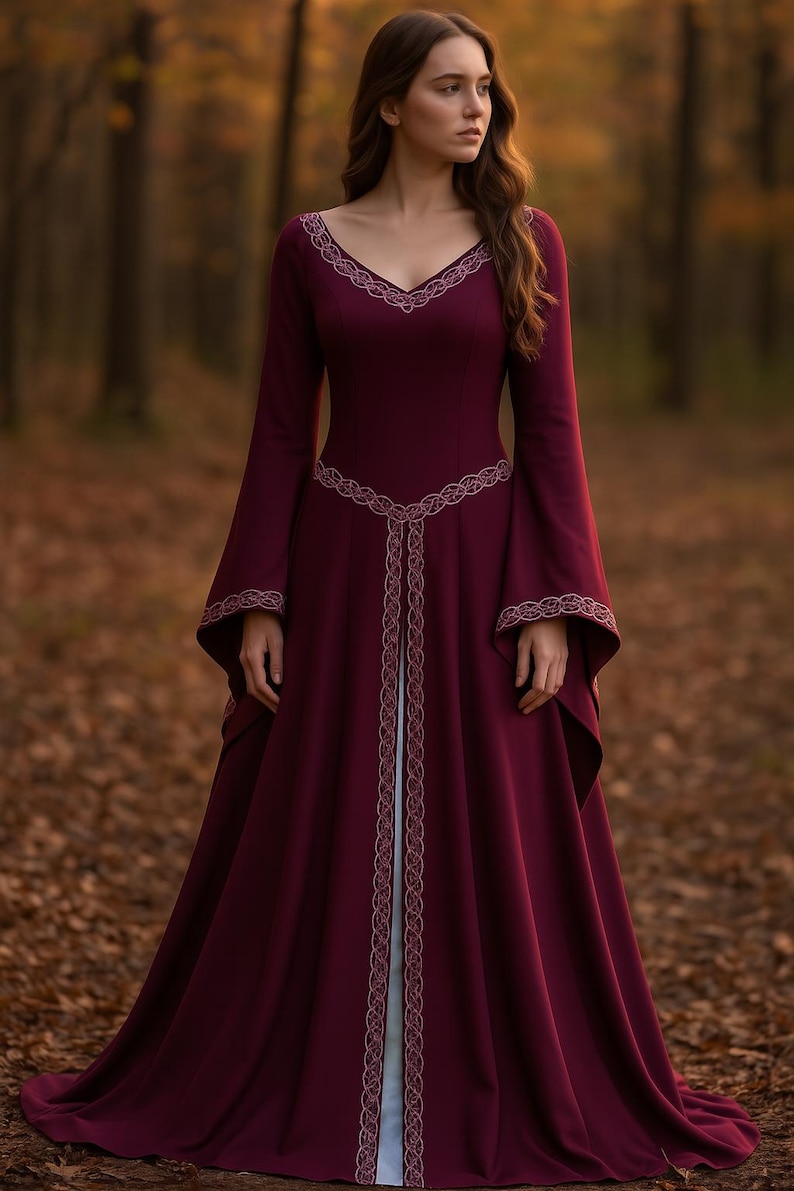 May include: A deep burgundy medieval gown with long, flared sleeves and a V-neck. The dress has detailed embroidered trim on the neckline, waist, and sleeves. The floor-length dress has a flowing skirt, ideal for historical events or themed occasions.