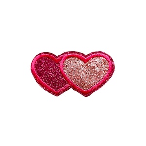 Puede incluir: Dos parches en forma de corazón con purpurina rosa y roja.