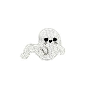 May include: White embroidered ghost with a smiling face and black eyes. The ghost has a small, curved mouth and a gray outline.