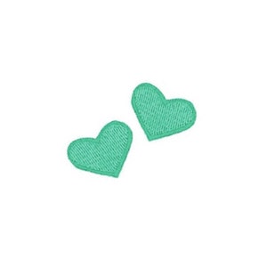 May include: Two small, green heart-shaped patches.