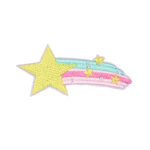 May include: Embroidered patch featuring a yellow star with a light blue, pink, and white comet tail. The comet tail has three small yellow stars. The patch is designed with a whimsical, cartoonish style.