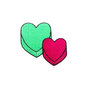 May include: Two embroidered felt hearts, one green and one pink, sewn together.