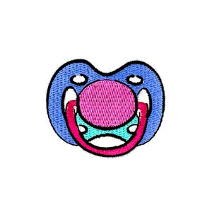 May include: An embroidered patch depicting a blue and pink pacifier. The pacifier is outlined in black and has a pink nipple with a white and blue ring around it.
