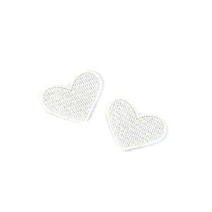 May include: Two white heart-shaped patches with a textured surface.
