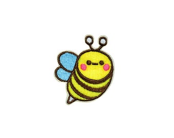 May include: A yellow and brown embroidered bee with blue wings and pink cheeks. The bee has a cute cartoon-like expression.