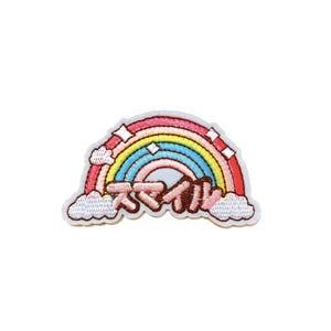 May include: Embroidered rainbow patch with a white border. The rainbow features red, orange, yellow, green, and blue arches. White clouds and Japanese text are at the bottom. The patch is on a white background.