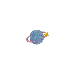 May include: A blue planet with a pink ring and a yellow star, embroidered on a white background. This is a cute and colorful iron-on patch.