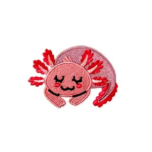 May include: A pink and red embroidered axolotl patch with a cute cartoon face. The axolotl is lying on its belly with its feathery gills spread out.