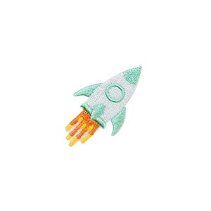 May include: A green and white rocket with orange flames shooting out the back. The rocket is flying upwards.