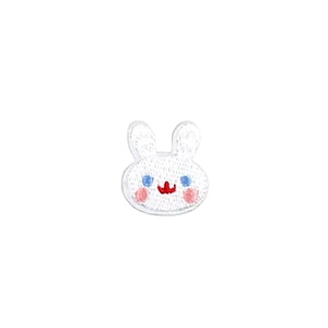 May include: A white embroidered bunny patch with blue eyes, pink cheeks, and a red mouth. The patch has a simple, cartoon-like design, perfect for adding to clothing or accessories. The bunny's face is centered on a white background.