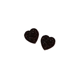 May include: Two black glitter heart-shaped earrings.
