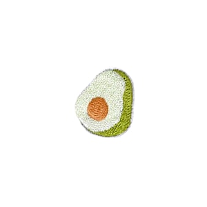 May include: A green and white embroidered avocado half with a brown pit.