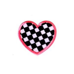 May include: A red heart-shaped patch with a black and white checkered pattern.
