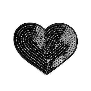 May include: A black heart-shaped patch covered in sequins. The sequins are arranged in a pattern that creates a swirling effect.