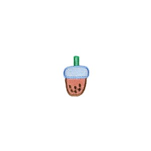 May include: A brown and blue acorn with a green stem. The acorn is embroidered with a pattern of small brown dots.