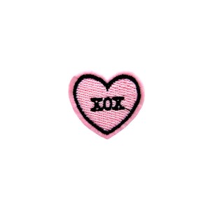 May include: Pink felt heart-shaped patch with black embroidered outline and the text "XOX" inside.