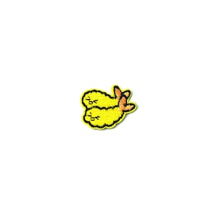 May include: A yellow embroidered patch of two cartoon shrimp with smiling faces.