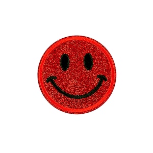May include: Red glitter smiley face patch with a black outline.