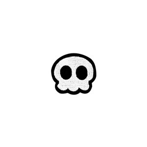 Puede incluir: Una calavera blanca con ojos negros, delineada en negro. La calavera es un diseño de dibujos animados simple.