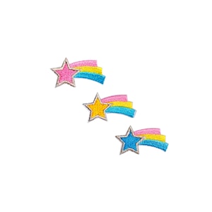 May include: Three embroidered iron-on patches featuring shooting stars with pink, yellow, and blue stripes.