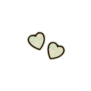 May include: Two sparkly iridescent heart-shaped stickers with black outlines.