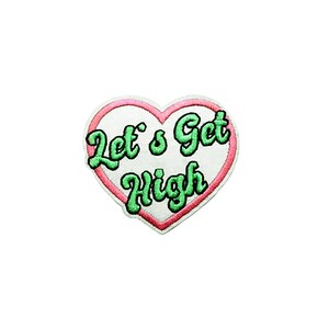 May include: A white heart-shaped patch with a pink outline. The text "Let's Get High" is embroidered in green.