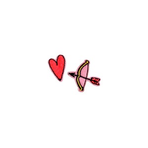 May include: A red heart and a pink bow and arrow with a gold outline. The heart and arrow are embroidered patches.