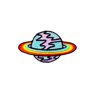 May include: An embroidered iron-on patch of a purple and blue planet with a rainbow ring around it.