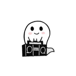 May include: A black and white embroidered patch of a ghost wearing a boombox with the text "101.1" on it.