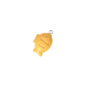 May include: A yellow fish-shaped charm with a silver loop for hanging.