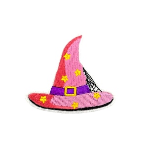 May include: Pink witch hat with yellow stars and a purple band. The hat has a spiderweb design on the side.