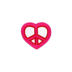 May include: Pink heart-shaped patch with a white peace sign inside. The peace sign is outlined in pink.
