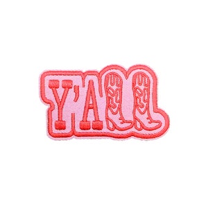 May include: Pink and red embroidered patch with the text "Y'ALL" and two pink cowboy boots.