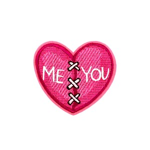 May include: A pink heart-shaped patch with the words "ME" and "YOU" embroidered in white. The heart is stitched with black thread, and the edges are outlined in a darker pink.