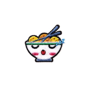 May include: White bowl with a cartoon face and chopsticks sticking out, filled with yellow noodles. The bowl has red cheeks and a red mouth. The text "zzz" is in blue above the bowl.