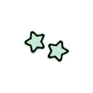 May include: Two sparkly green stars with black outlines.